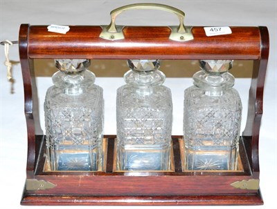 Lot 457 - A mahogany three bottle tantalus