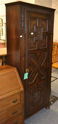 Lot 1009 - An oak hall cupboard