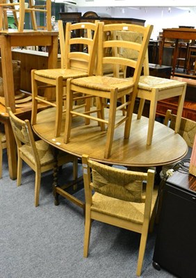 Lot 1013 - Oak barley twist drop leaf table and seven light oak rush seated chairs