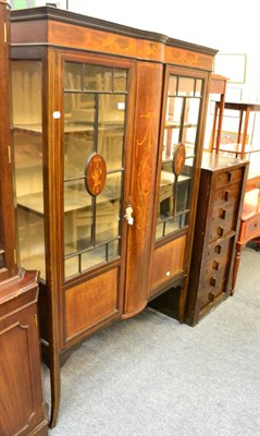 Lot 1022 - An Edwardian inlaid glazed cabinet and an oak Wellington chest (2)