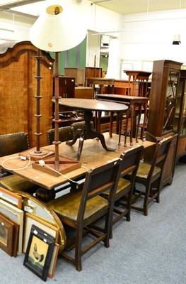 Lot 1024 - An oak carved refectory style table and a set of six carved oak chairs with green leather seats