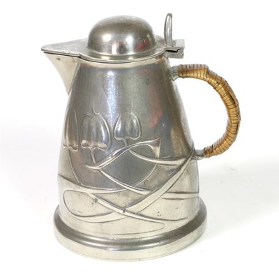 Lot 522 - Liberty & Co: A Tudric Pewter Hot Water Jug, with a domed hinged cover, rattan covered handle, with