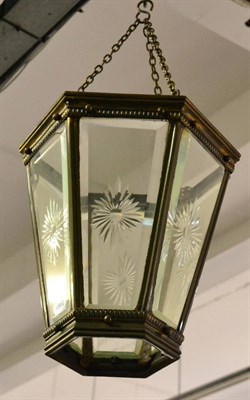 Lot 1049 - A vintage brass hall lantern with star cut glass panels