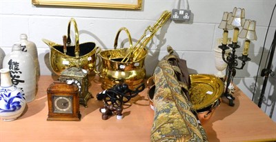 Lot 1059 - A collection of brass including coal scuttles, a companion set, a decorative plaque, etc,...