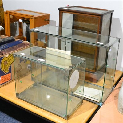 Lot 1060 - A Japanese oak and glazed cabinet and two Japanese glass cabinets (3)