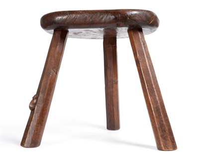 Lot 534 - Mouseman: A Robert Thompson English Oak Cow Stool, the solid dished top on three octagonal...