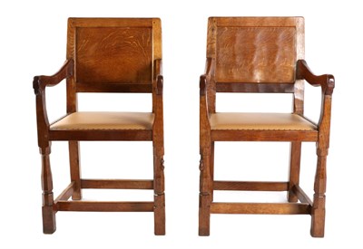 Lot 538 - Mouseman: A Pair of Robert Thompson English Oak Panel Back Armchairs, with cow hide seats, set-back