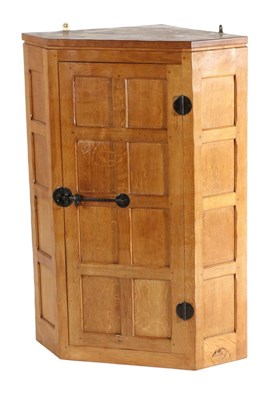 Lot 543 - Mouseman: A Robert Thompson English Oak Hanging Corner Cupboard, the single door opening to...