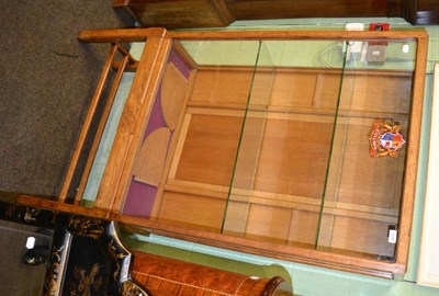 Lot 1248 - An Arts & Crafts display cabinet with glazed front carved with a swallow