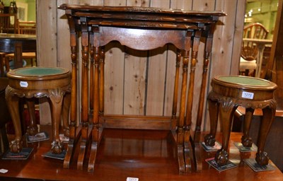 Lot 1272 - A pair of small circular walnut stands and a nest of three walnut tables