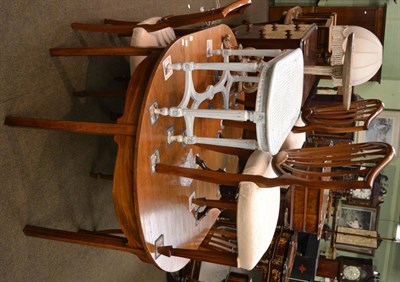 Lot 1282 - A late Georgian mahogany D-end dining table with fly legs, additional leaf and brass clips,...