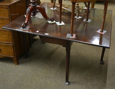 Lot 1298 - An 18th century mahogany drop leaf table on pad feet