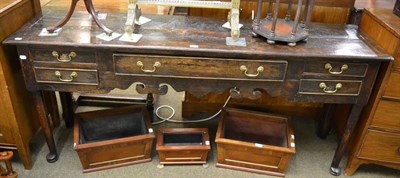 Lot 1305 - An 18th century oak low dresser, with a moulded top and five drawers to the shaped apron, on turned