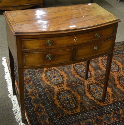 Lot 1312 - A late George III mahogany bow-fronted side table of three drawers