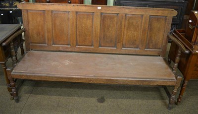 Lot 1321 - An oak panel back settle