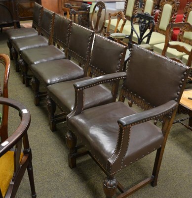 Lot 1335 - A set of six hide upholstered oak framed dining chairs including a carver