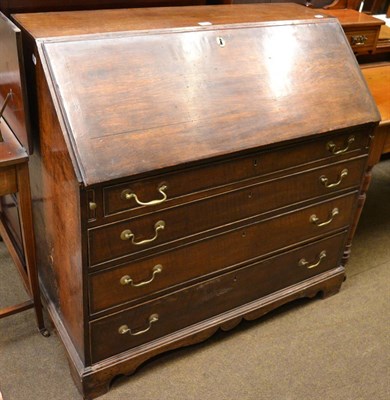 Lot 1360 - A George III oak bureau, the fitted interior with faux book drawers