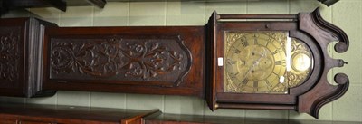 Lot 1392 - A 19th century oak and mahogany longcase clock with carved door and brass arched dial, 8-day, James