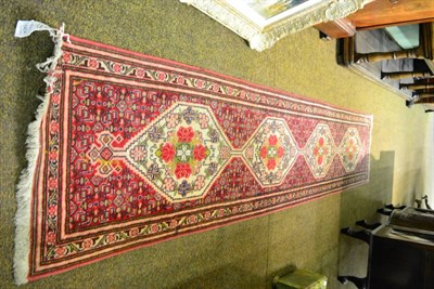 Lot 1404 - A very narrow Bidjar runner, Persian Kurdistan, the rose field of Herati design with a column...