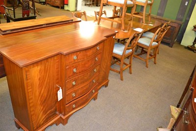 Lot 1348A - A mid 20th century dining table and a bow fronted sideboard (with key)