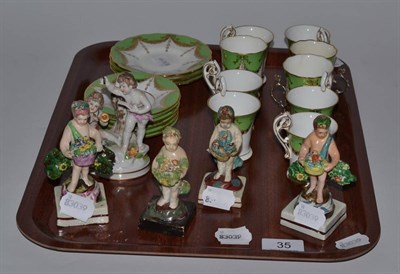 Lot 35 - Four Staffordshire pottery cherubs, another group and a Coalport part coffee set