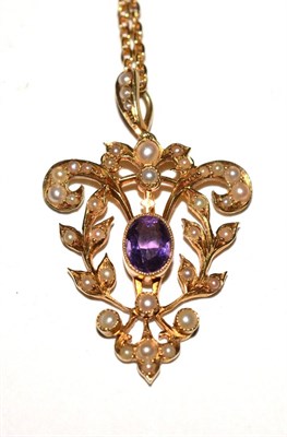 Lot 121 - An amethyst and seed pearl pendant, stamped '15ct' on chain