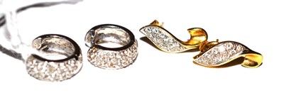 Lot 137 - A pair of diamond cuff earrings and a pair of diamond scroll earrings (2)