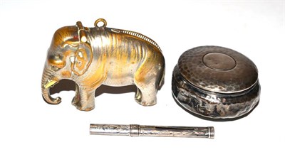 Lot 214 - A small hammered silver snuff box, a silver propelling toothpick and a brass elephant form...