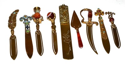 Lot 223 - A group of nine brass bookmarks, some with banded agate and enamel pommels