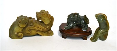 Lot 248 - Three Oriental carved green hardstone models of a dragon, a monkey and a dog of Fo
