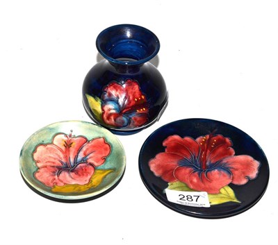 Lot 287 - Two Moorcroft dishes and a small Moorcroft vase, each decorated in the Hibiscus pattern