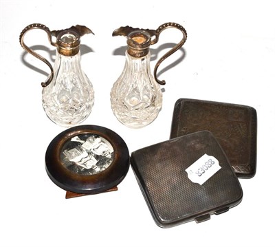 Lot 289 - Two silver cigarette cases, a photograph frame and two silver mounted glass jugs