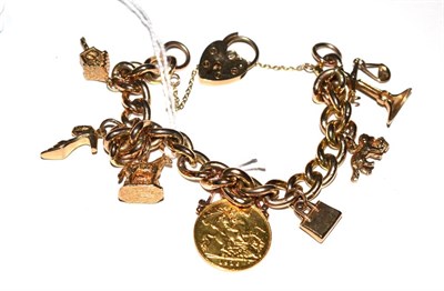 Lot 325 - A charm bracelet with 9ct gold and other charms and a soldered Edward VII half sovereign