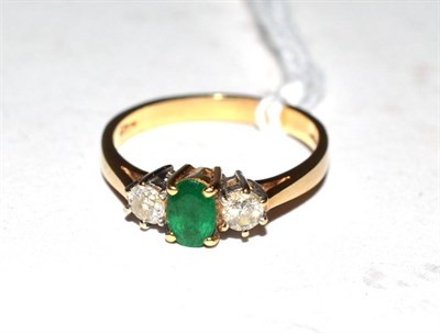 Lot 343 - An 18ct three stone emerald and diamond ring