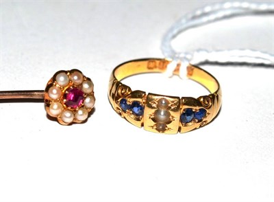 Lot 348 - An 18ct gold sapphire and seed pearl ring and a ruby and seed pearl cluster stick pin (2)