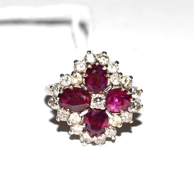 Lot 359 - A diamond and ruby set cruciform floral ring stamped 18ct