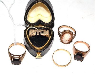 Lot 361 - A band ring stamped '750', two 9ct gold garnet set rings, a 9ct gold cameo ring and another 9ct...