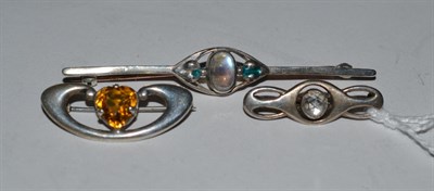 Lot 362 - An Art Nouveau moonstone and enamel bar brooch, stamped 'LIBERTY', and two other Art Nouveau...