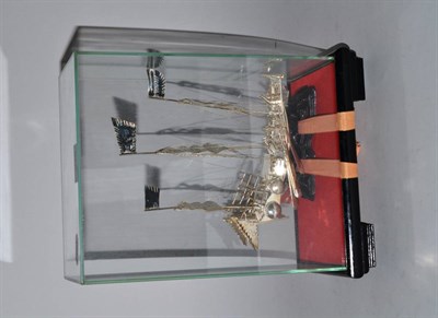 Lot 370 - A white metal model of a Chinese junk in a glass case