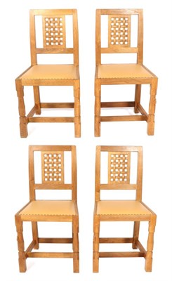 Lot 599 - Mouseman: Four Robert Thompson English Oak Lattice Back Dining Chairs, with tan cow hide...