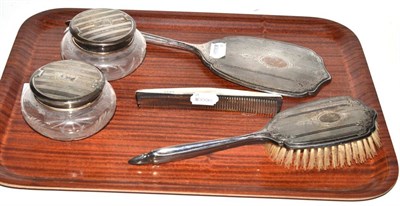 Lot 400 - A three piece silver backed dressing table set comprising brush, comb and hand mirror, together...