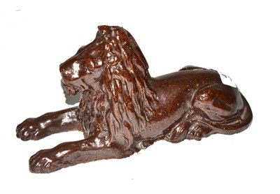 Lot 411 - A 19th century salt glazed figure of a recumbent lion