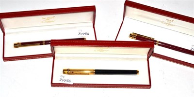 Lot 414 - Three cased Must de Cartier pens (two ballpoint pens and one fountain pen)