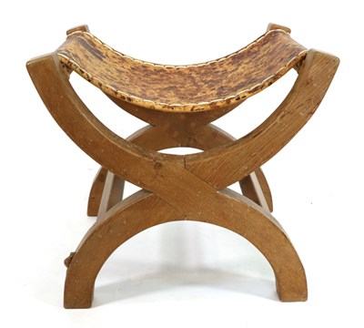 Lot 602 - Mouseman: A Robert Thompson Oak Cross Framed Stool, the slung hide seat supported by two X...