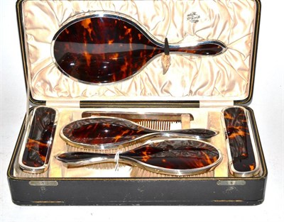 Lot 439 - A six piece silver and tortoiseshell mirror and brush set, Chester, 1924 cased