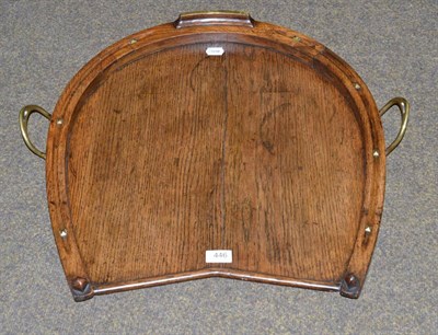 Lot 446 - A novelty Edwardian oak tray in the form of a horse's hoof, with brass studs and twin...