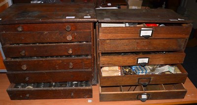 Lot 1068 - Two small wooden cabinets containing watch glasses and other clock parts