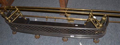 Lot 1084 - A pierced fender, pair of brass andirons and a brass towel rail