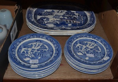 Lot 1113 - A set of four Willow platters and twelve plates