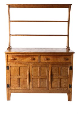 Lot 619 - King Post of Burton Leonard: A Robert E Ingham English Oak Dresser, the open back rack with two...